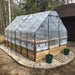 A transparent greenhouse cover is fitted over an Outdoor Living Today 8×12 Raised Garden Bed, protecting plants while letting in sunlight