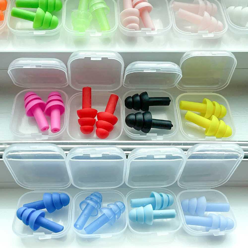 A variety of Dreampod Three Flange Silicone Earplugs in vibrant colors neatly organized in individual plastic cases