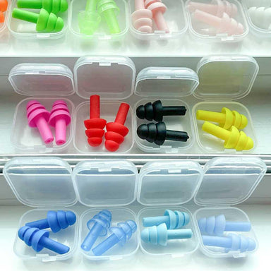 A variety of Dreampod Three Flange Silicone Earplugs in vibrant colors neatly organized in individual plastic cases