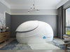 A white Dreampod Sport Float Pod is displayed in a softly lit, elegant room with a modern rug and decorative lighting