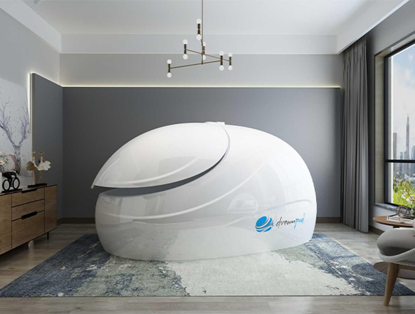 A white Dreampod Sport Float Pod is displayed in a softly lit, elegant room with a modern rug and decorative lighting