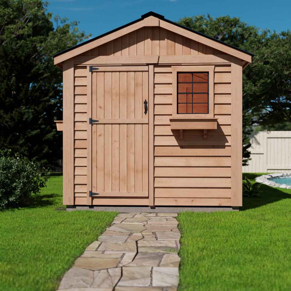 A wooden shed with a front door, small window, and flower box, placed along a stone path, showing the Outdoor Living Today 8×8 Gardener Shed