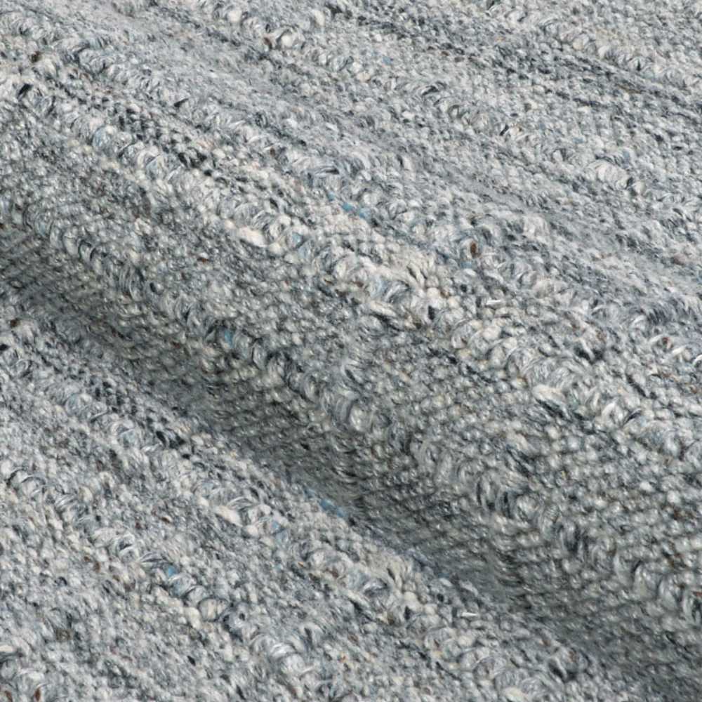 A zoomed-in image of the Couristan Ascot Indoor/Outdoor Rug - Windowpane/Tweed reveals its thick, woven surface with loops and a mix of gray tones
