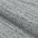 A zoomed-in image of the Couristan Ascot Indoor/Outdoor Rug - Windowpane/Tweed reveals its thick, woven surface with loops and a mix of gray tones