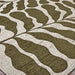 A zoomed-in section of the Couristan Castille Indoor/Outdoor Rug - Fiore/Tea Leaf showcases its symmetrical, organic leaf-like design in tea leaf green and beige
