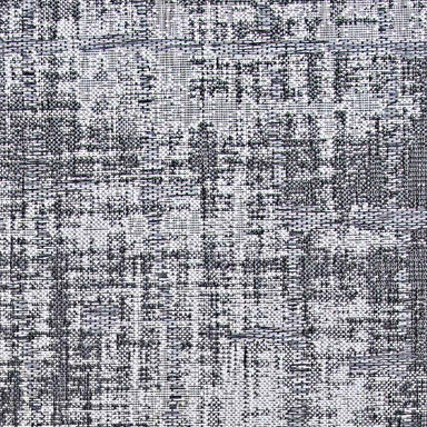 A zoomed-in section of the Couristan Charm Indoor/Outdoor Rug - Tiverton/Anthracite-Light Grey highlights the intricate, pixelated pattern in black and grey shades