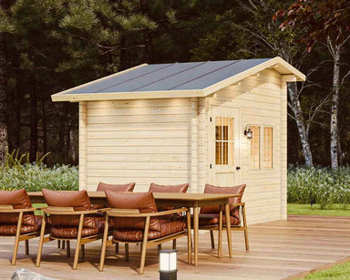 Back corner of the Sawmill Structures Bluewater Den 67 Garden Room, highlighting its clean wood finish and tall roof behind a dining table