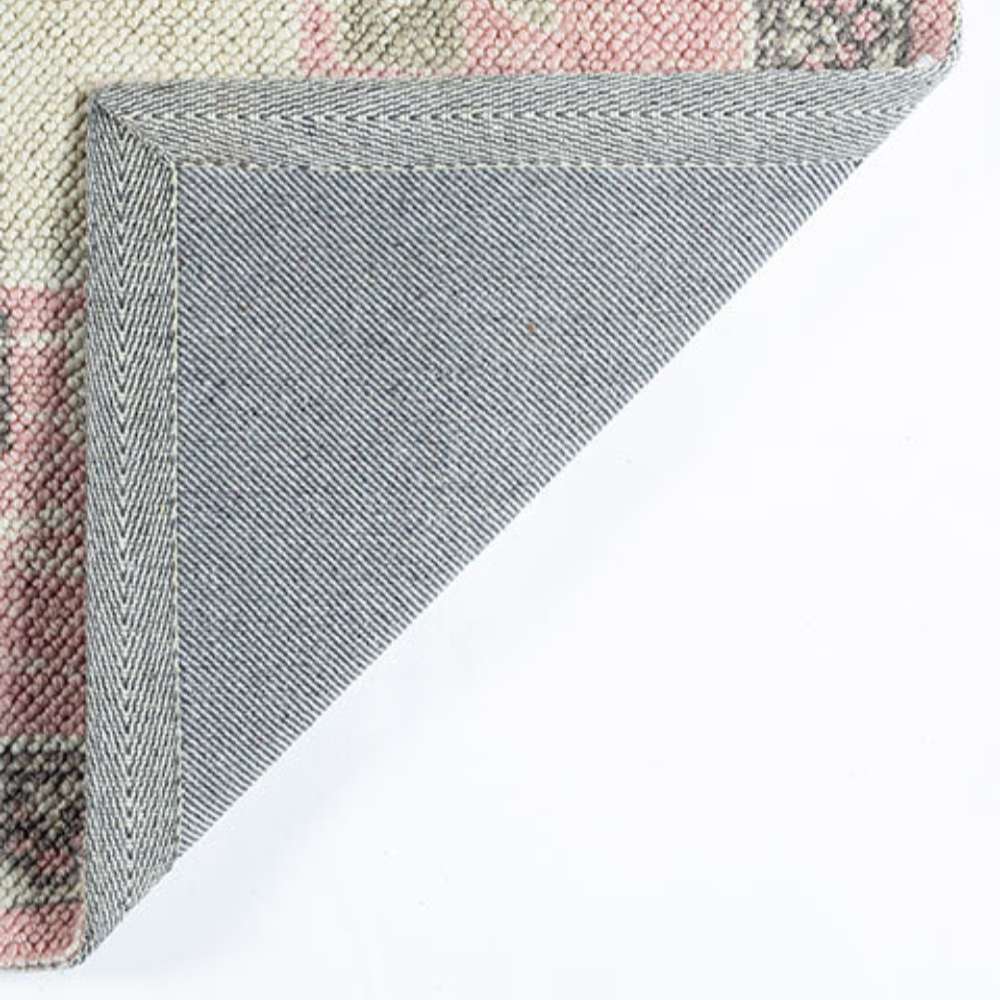 Back corner shows the sturdy gray fabric backing of Momeni Anatolia Indoor Rug - ANA-2 Pink
