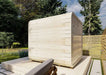 Back side of Sawmill Structures Box Sauna revealing its smooth, curved wooden exterior with no windows for privacy