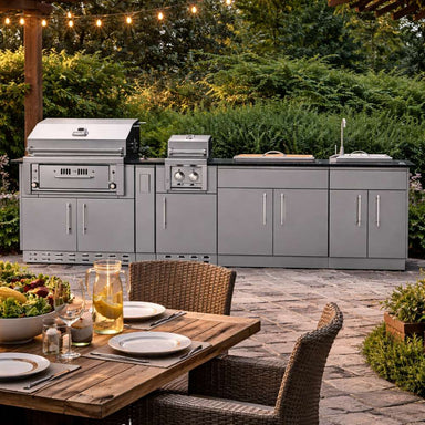 Backyard dining setup with a stainless steel cooking island from the Sunstone Alamo 10ft Outdoor Cabinet Island Package with Hybrid Grill