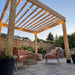 Backyard seating area under string lights featuring the Outdoor Living Today Western Red Cedar Urban Escape Pergola