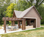 Beautifully crafted Brookside Timber Frame Denalivue Pavilion stands in a lush backyard, featuring a wooden pergola, an inviting seating area, and a covered space