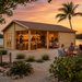 Bendy 70 transformed into an upscale golden-hour entertainment bar, with adults socializing beside a Florida Keys mangrove waterfront.