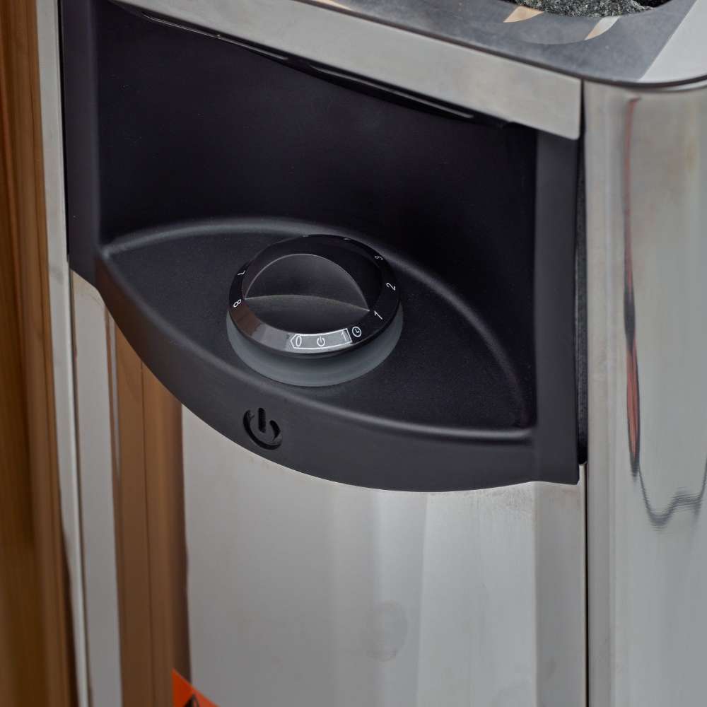 Black control dial on the front of the stainless steel Harvia stove in Golden Designs Gargellen 5 Person Hybrid Outdoor Sauna
