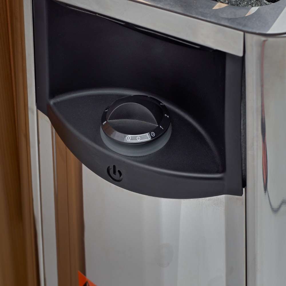 Black control dial on the front of the stainless steel Harvia stove in Golden Designs Kuusamo 6 Person Traditional Sauna