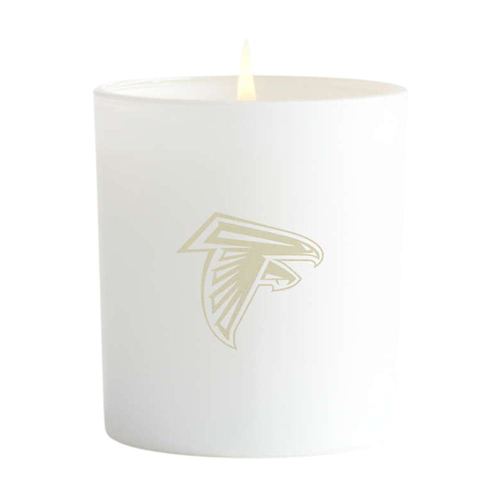 Blanc white single-wick Crate & Barrel Monochrome Scented Candle featuring a gold Atlanta Falcons logo on the front