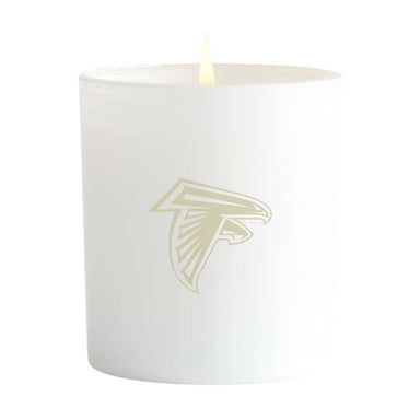 Blanc white single-wick Crate & Barrel Monochrome Scented Candle featuring a gold Atlanta Falcons logo on the front