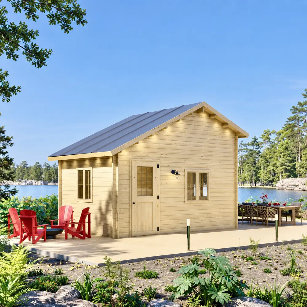 Front view of the lakeside BlueWater Bungalow 160 with a gable roof, wooden deck, red Adirondack chairs, and outdoor dining furniture.