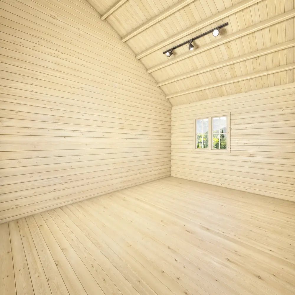 Bright empty open-plan interior of the BlueWater Bungalow 160 with natural pine walls, wooden flooring, and a high vaulted ceiling.