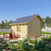 Rear-side view of the BlueWater Bungalow 160 with red Adirondack chairs and a fire pit surrounded by lush lakeside landscaping.