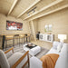 Bright pine interior of the BlueWater Loft 160 38mm with bar seating, white lounge furniture, a cabinet, and loft ladder.