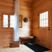 wooden entryway in the BlueWater Loft 160 38mm with a rustic bench, hat rack, wicker basket, curtain, and paneled door.