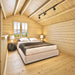 Peaceful BlueWater Loft 160 38mm bedroom with a double bed, two lamps, exposed rafters, and a mountain-view window.