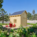 Rear view of the BlueWater Loft 160 38mm with a clean wooden facade and red Adirondack chairs around a fire pit.