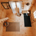 Top-down view of the BlueWater Loft 160 38mm entryway with pine flooring, sheer curtains, a bench, woven basket, and black mats.