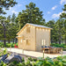 Two-story BlueWater Loft 160 38mm cabin with warm exterior lights, a spacious dining deck, and surrounding pine trees.