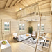 Bright double-height living room in the BlueWater Loft 160 with a white sofa, loft railing, and wooden access ladder.
