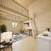 BlueWater Loft 160 interior with a compact white kitchen, comfortable sitting area, bar seating, and loft ladder.