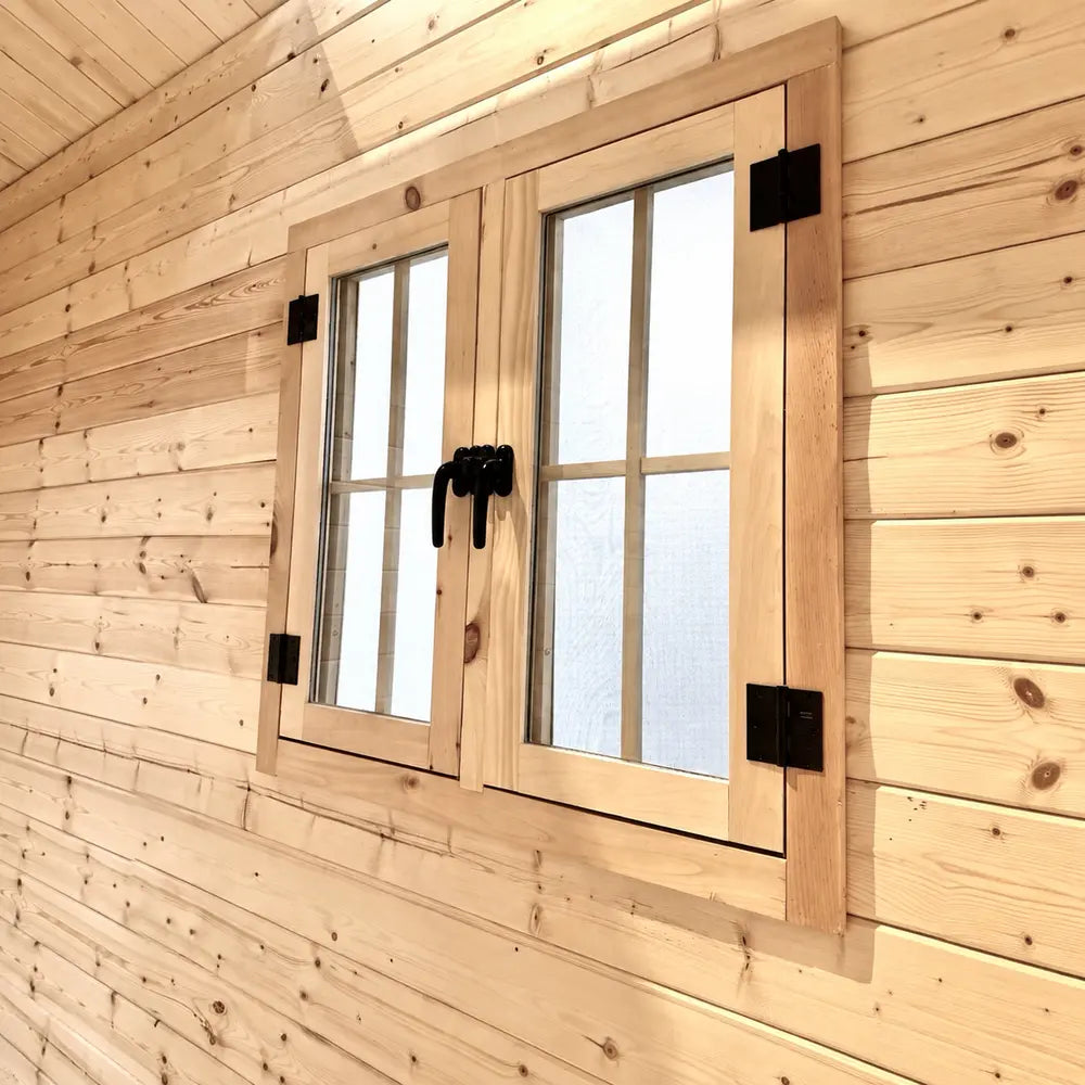 Interior close-up of the Bluewater Den 67 double window with frosted panes, black hinges and paired center handles.