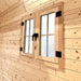 Interior close-up of the Bluewater Den 67 double window with frosted panes, black hinges and paired center handles.