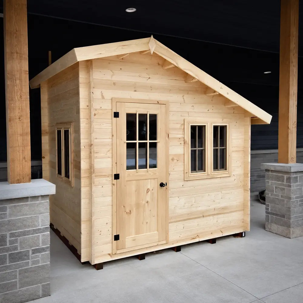 Left-angled view of the Bluewater Den 67 showing the windowed front door, paired front windows and an additional side window.