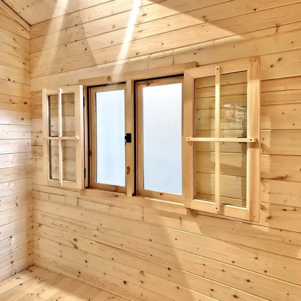 Bluewater Den 67 interior window with both wooden shutters fully open around frosted panes as sunlight crosses the pine wall.