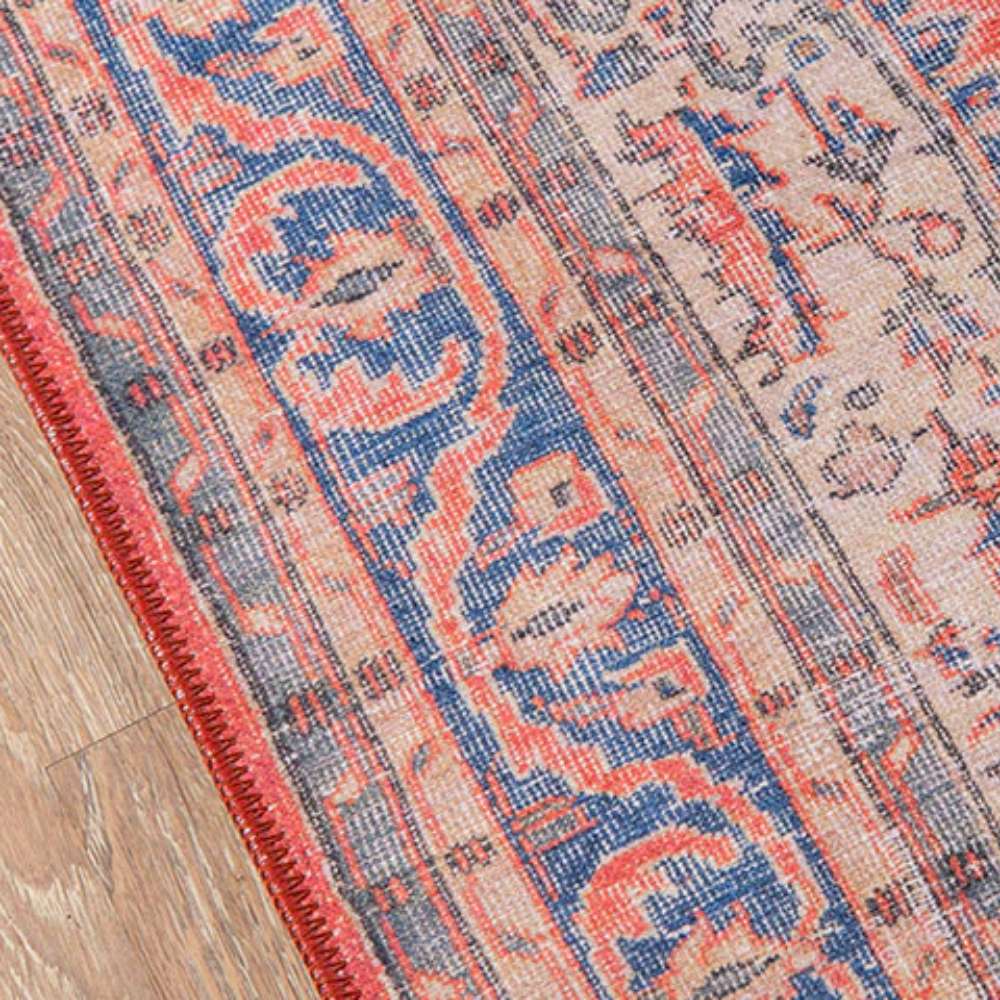 Border of Momeni Afshar Indoor Rug - AFS12 Red highlights intricate blue and red floral patterns with precise stitching along the edges