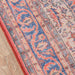 Border of Momeni Afshar Indoor Rug - AFS12 Red highlights intricate blue and red floral patterns with precise stitching along the edges