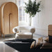 Bright living room featuring Crate & Barrel Annie 38" Natural Storage Cabinet paired with a curved lounge chair and indoor tree