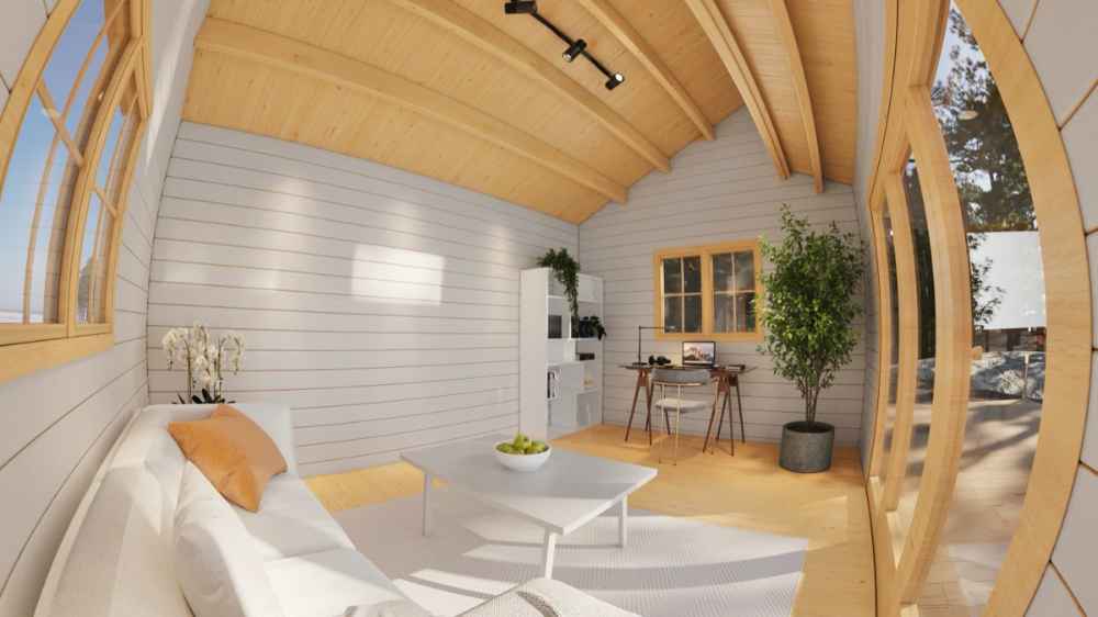 Bright and modern interior of the Sawmill Structures The Versa 160 Atrium 70MM Garden Room includes a sofa, coffee table, and work desk