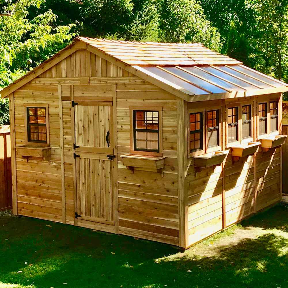 Bright sunlight hits the Outdoor Living Today 12×12 Sunshed Garden Shed, highlighting its five side windows, two front windows, and rustic wood finish