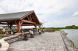 Brookside Timber Frame Combolan Estate Pavilion offers a relaxing waterfront retreat with ample seating, a covered roof, and a breathtaking landscape view
