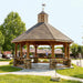 Brookside Timber Frame Lakeside Majestic Pavilion in a park with stone base columns and a spacious covered design