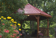 Brookside Timber Frame Lakeside Majestic Pavilion surrounded by lush greenery with strong timber posts and open shade