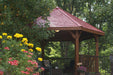Brookside Timber Frame Lakeside Majestic Pavilion surrounded by lush greenery with strong timber posts and open shade