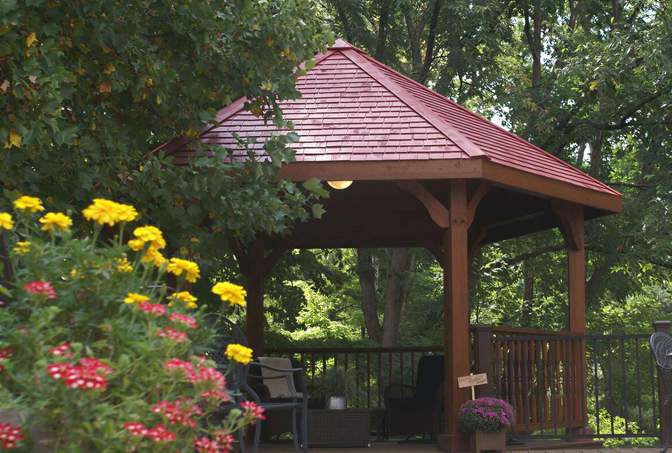 Brookside Timber Frame Lakeside Majestic Pavilion surrounded by lush greenery with strong timber posts and open shade