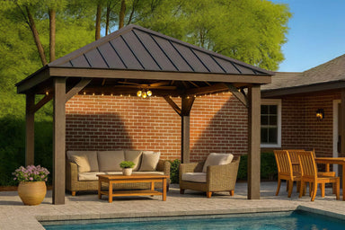 Brookside Timber Frame Stonewood Pavilion covers a cozy outdoor seating area with cushioned chairs and a sofa, set against a brick house and poolside patio