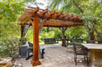 Brookside Timber Frame Highlan Oasis Pergola is a beautifully crafted wooden pergola set in a lush backyard