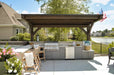 Brookside Timber Frame Ledgefield Pavilion creates a cozy yet sophisticated outdoor dining and cooking area