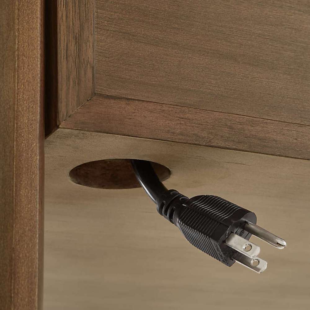 Cable management opening on Crate & Barrel Tate Walnut Bookcase Desk with Outlet keeps cords neatly organized